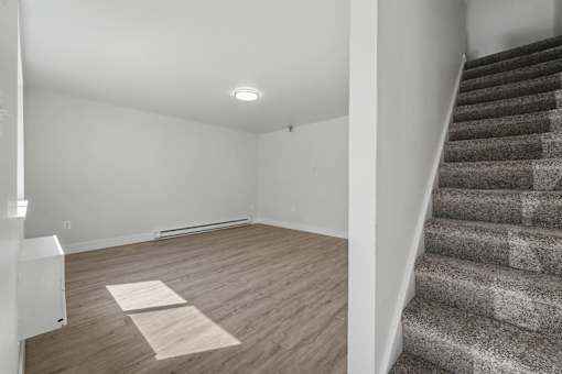 A room with a staircase and a light on the ceiling.