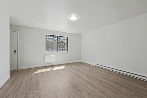 A room with a window and a door.