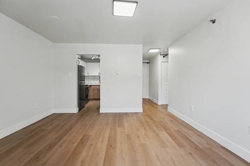 A room with wooden floors and white walls.