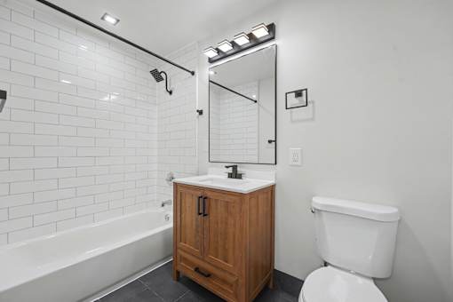 A white toilet sits next to a sink in a bathroom.