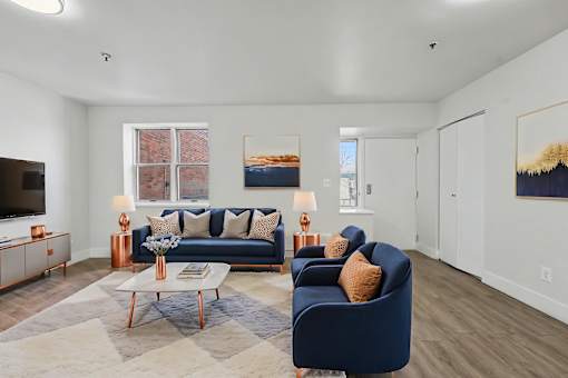 A living room with a blue couch and a coffee table.