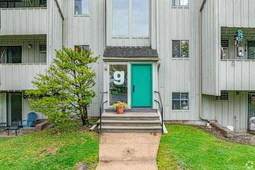 A green door is on the side of a building.