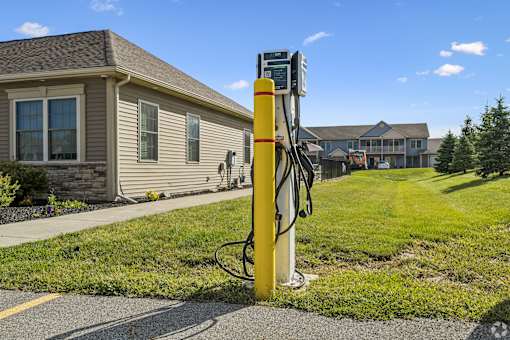 A yellow and white parking meter sits on the side of a road.