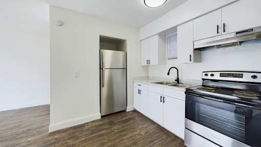 A kitchen with a stainless steel refrigerator and oven.