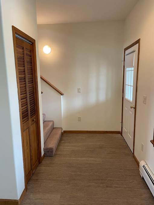A room with a staircase and a window.