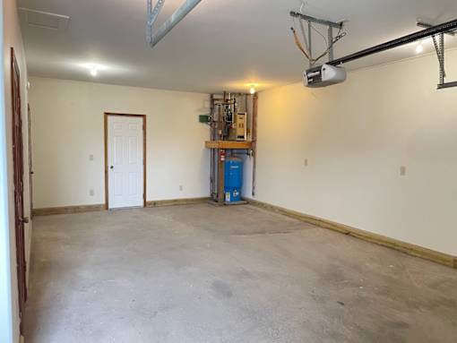A room with a white door and a white ceiling with a light fixture.