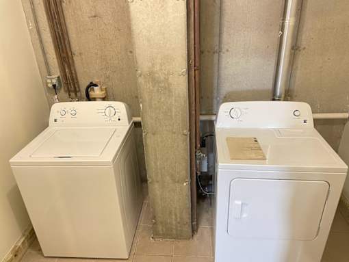 A washer and dryer in a small bathroom.
