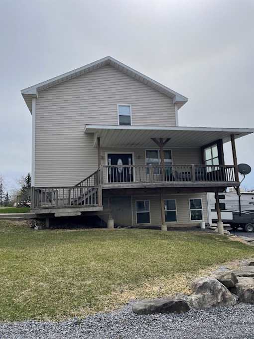 A house with a grey roof and a balcony.