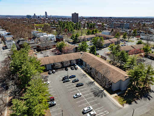 A parking lot with cars and a building in the background.