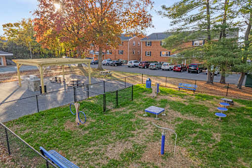 A playground with a swing set and a blue slide.