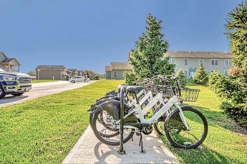 A bicycle is parked on a sidewalk in front of a house.