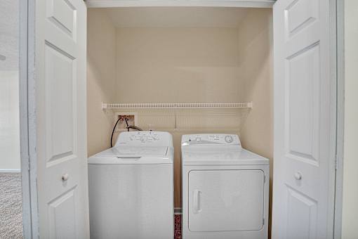 A small laundry room with a washer and dryer.