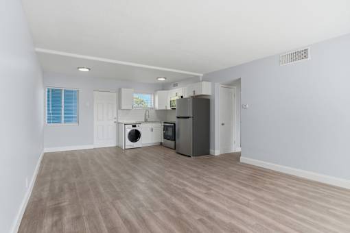 A kitchen area with a dishwasher, microwave, and oven.