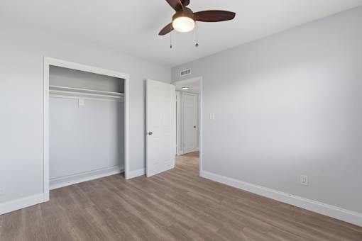 A room with a ceiling fan and light fixture.