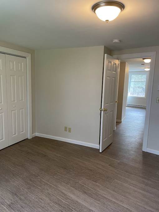 A room with a white door and a light on the ceiling.