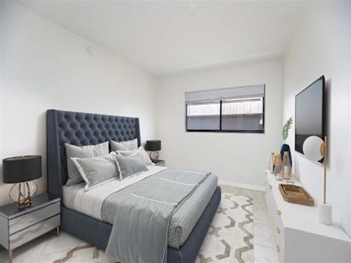 a bedroom with a bed and a tv