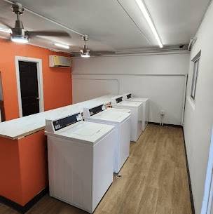 a row of white washing machines in a room