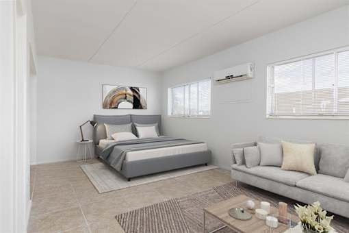 a bedroom with a bed and a couch