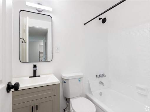 a bathroom with a sink toilet and a mirror