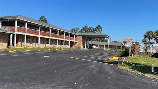 an empty parking lot in front of a building