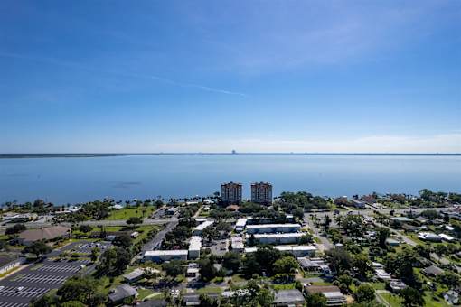 an aerial view of a city with a body of water