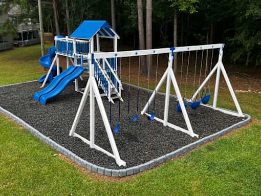 a playground with a swing set and a slide