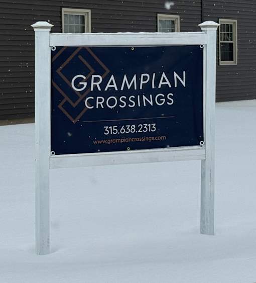 A sign for Grampian Crossings in the snow.