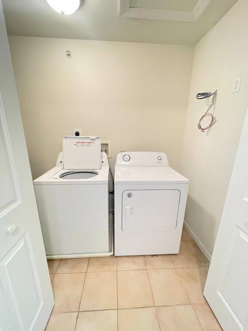 A small bathroom with a toilet and a washer and dryer.