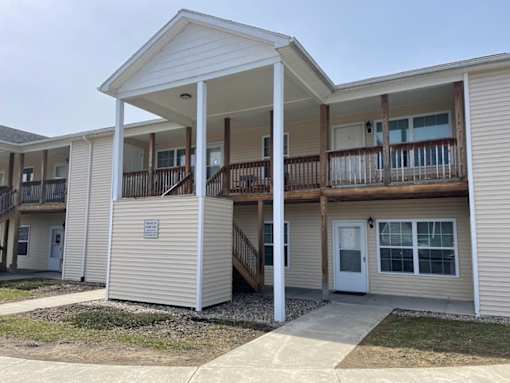 A row of houses with balconies and doors.
