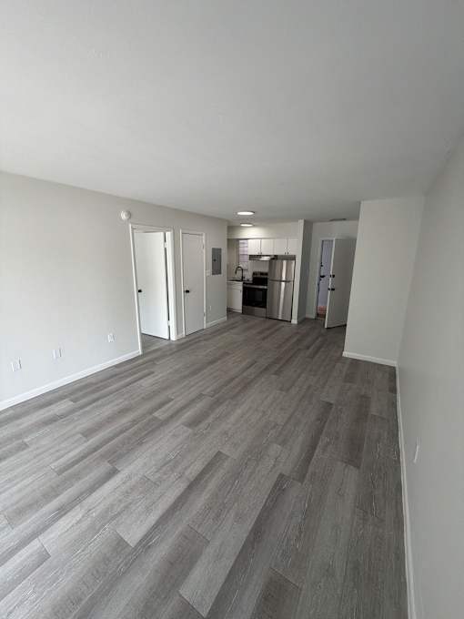 A room with a wooden floor and white walls.