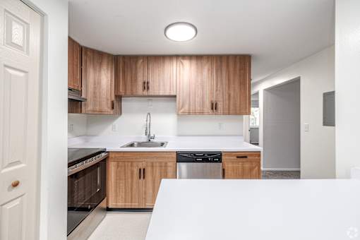 A kitchen with wooden cabinets and stainless steel appliances.