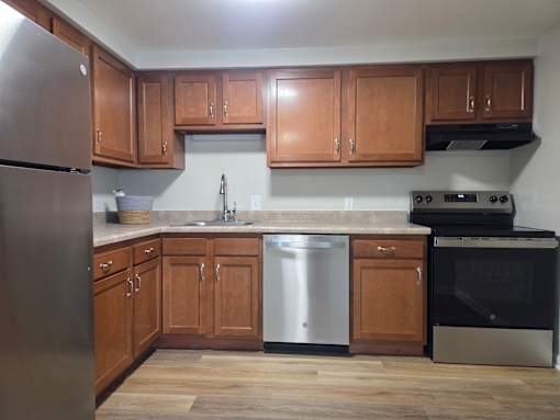 A kitchen with wooden cabinets and stainless steel appliances.