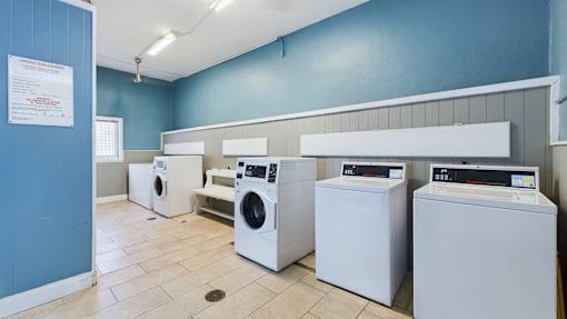 A row of washing machines in a laundromat.