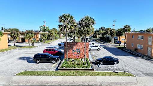 A street view with a brick building in the center.