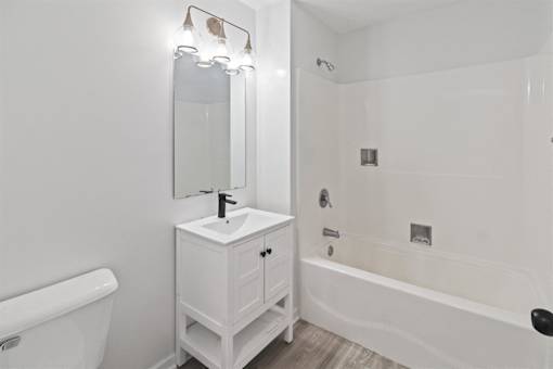 a bathroom with a sink and a tub and a mirror