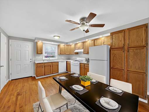 A kitchen with a table set for two.