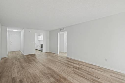 A room with wooden floors and white walls.