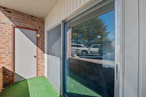 A view of a parking lot through a window.