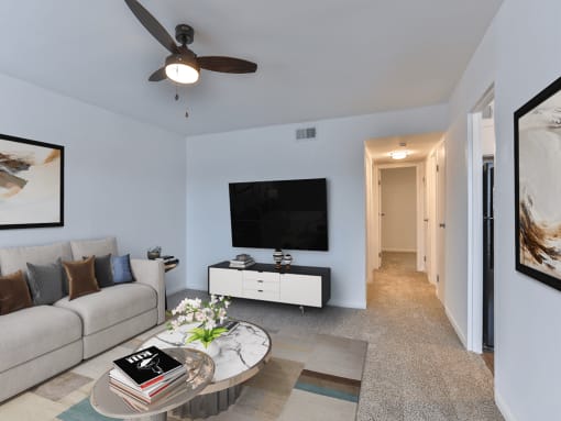 a living room with a couch and a table and a tv