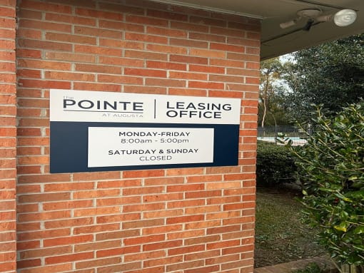 a sign on the side of a brick building