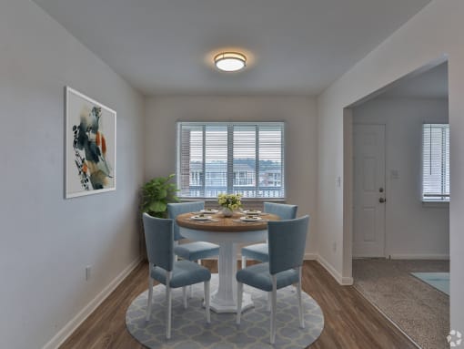 a dining room with a table and chairs and a window