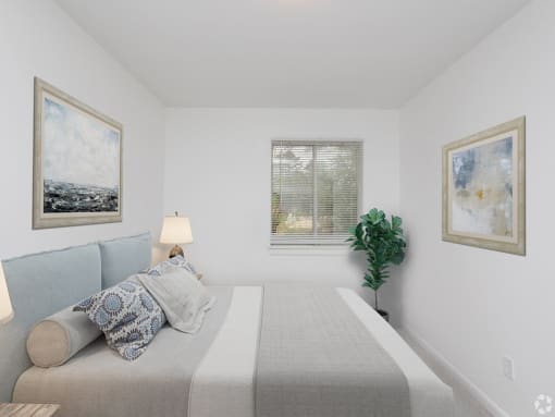 a bedroom with a bed and paintings on the wall