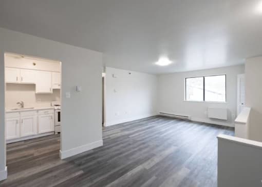 an empty living room and kitchen in a new home