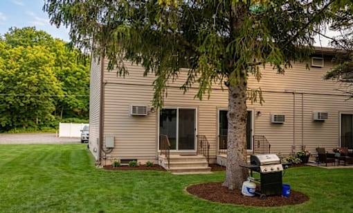A house with a tree in front of it.