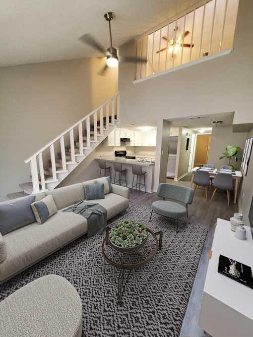 A living room with a staircase and a dining area.