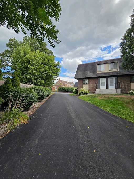 A residential street with houses on both sides.