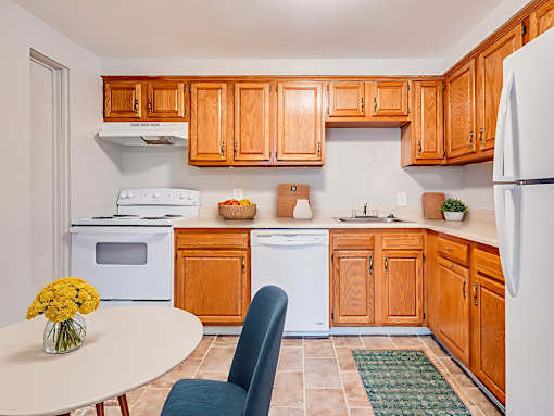 A kitchen with wooden cabinets and a white refrigerator.