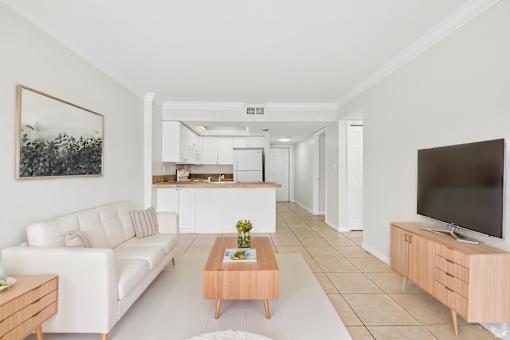 A living room with a white couch and a coffee table.