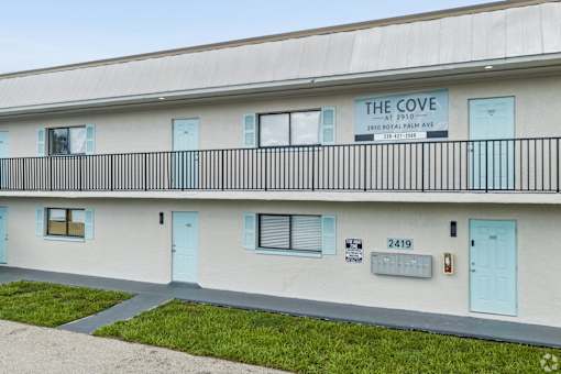 The Cove is a building with a balcony and blue doors.