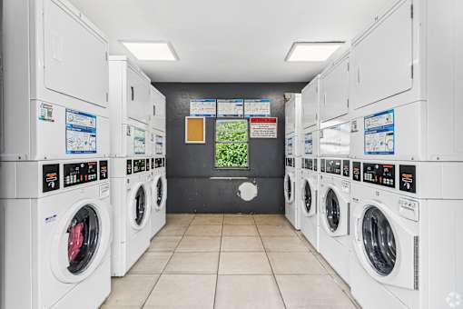 A row of washing machines in a laundromat.